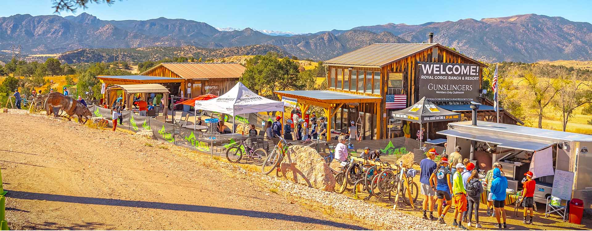 The Royal Gorge Ranch & Resort clubhouse on its pinyon-covered hills, with the Sangre de Cristo mountains behind